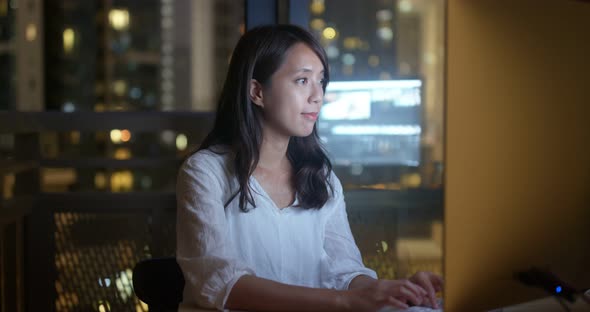 Woman work on computer at night