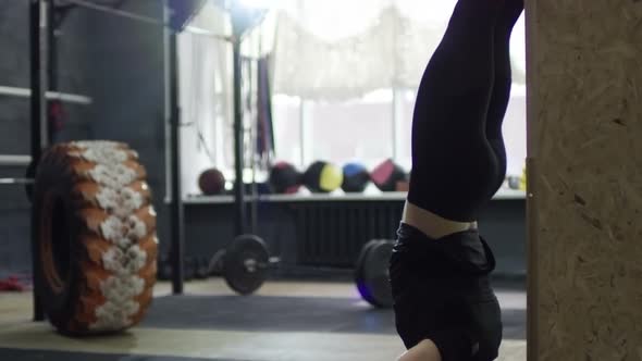 Sportswoman Doing Handstand Push-Ups