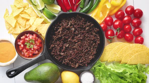 Ingredients for Chili Con Carne in Frying Iron Pan on White Wooden Table