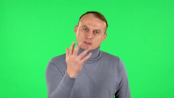 Portrait of Male Is Scolding, Shaking His Index Finger and Threatening with a Fist. Green Screen