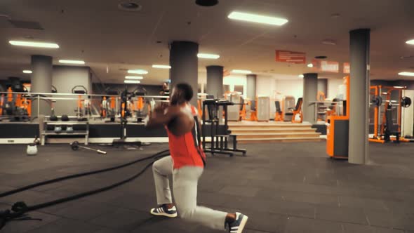 Man doing some lunges in the gym.