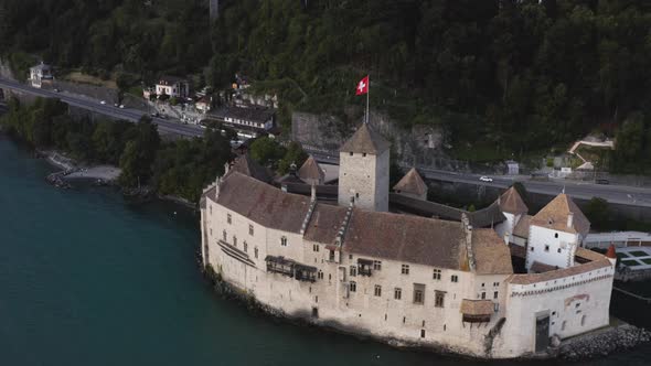 Aerial shows Chillon castle in the evening close from Lausanne, Switzerland