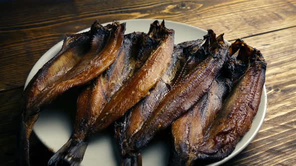 Passing Plate Of Kippers On Table