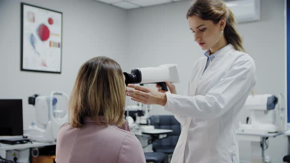 The Ophthalmologist Examines the Patient's Eye