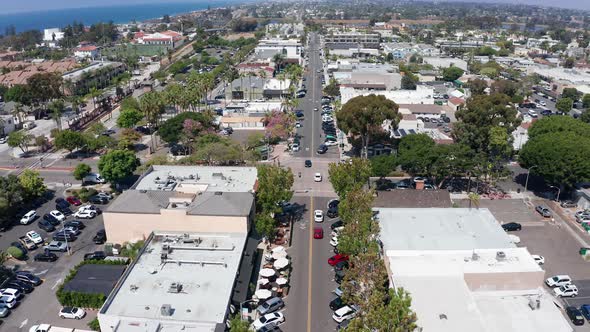 Aerial shot flying over houses and roads in Carlsbad city in California, America