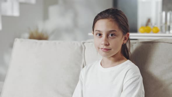 Portrait of Pretty Female Teen Resting on Couch