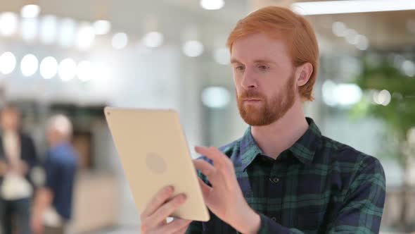 Portrait of Beautiful Beard Redhead Man Using Digital Tablet