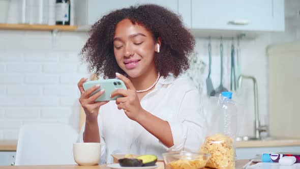 African American Woman Holds Smartphone Horizontally Plays Games Online