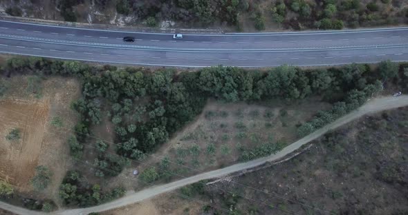 Aerial top view of road in country side with car traveling and driving - concept of transport