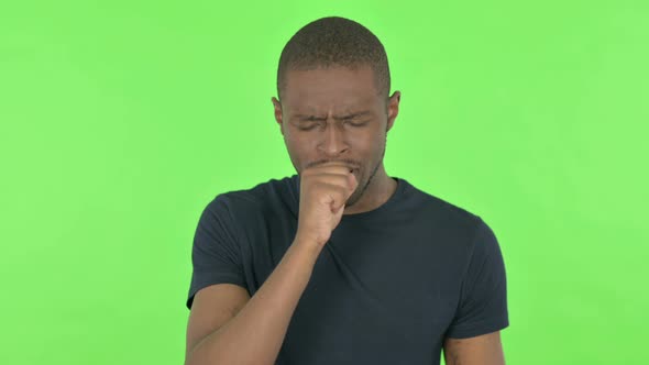 Unwell Young African Man Coughing on Green Background