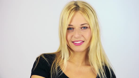 A Young Attractive Woman Smiles at the Camera - Face Closeup - White Screen Studio