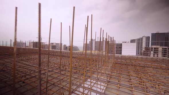 Iron reinforcement is basis for pouring foundation of house with concrete slab.