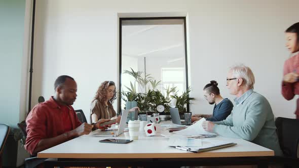 Time Lapse of Mixed-Aged Diverse Employees Working in Open Space Office