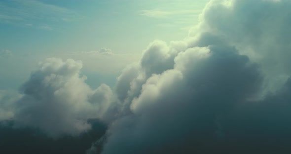 Aerial Fly Above Clouds with Blue Sky in Backgroubnd on Beautiful Sunny Day