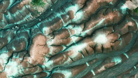 Aerial : Top view of dry land, brown and white soil in Cheltenham Badlands, Ontario Canada. Flying o