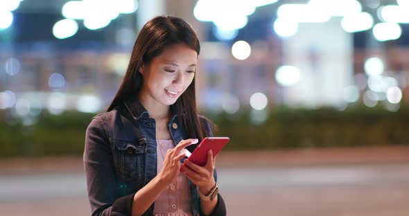 Woman use of mobile phone in city