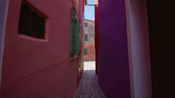 Narrow Paved Walkway Between Colored Houses in Burano