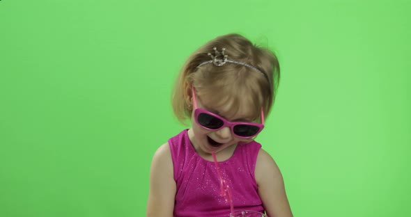 Happy Four Years Old Child in Pink Dress Drinks Milkshake Cocktail. Chroma Key