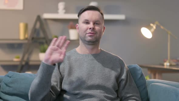 Portrait of Casual Man Waving at the Camera