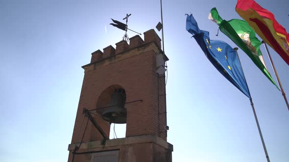 Waving flags next to Torre de la Vela