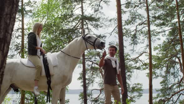 Woman Riding Horse on Romantic Date