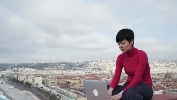 Woman Chatting Online and Smiling Outdoor