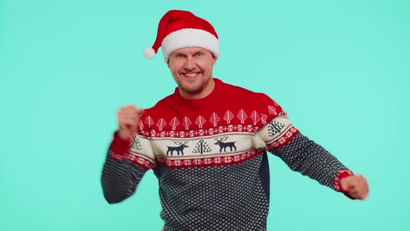 Man in Sweater Santa Christmas Hat Dancing Trendy Dance for Social Media Fooling Around Having Fun