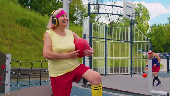 Senior Woman Grandmother After Sport Basketball Training Sitting Listening Music on Playground Yard