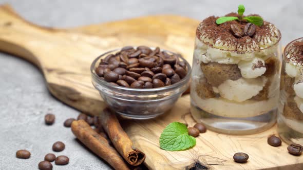 Classic Tiramisu Dessert in a Glass on Dark Concrete Background