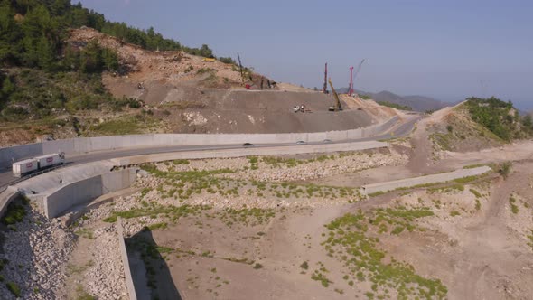 Aerial View of Road with Cars Passing Through Mountains