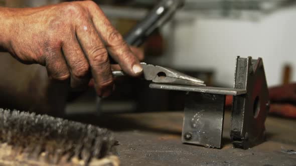 Hands of welder working on a piece of metal