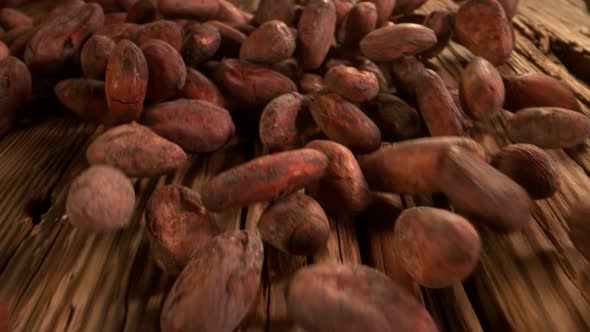 Super Slow Motion Detail Shot of Chocolate Beans Rolling Towards on Wooden Background at 1000Fps