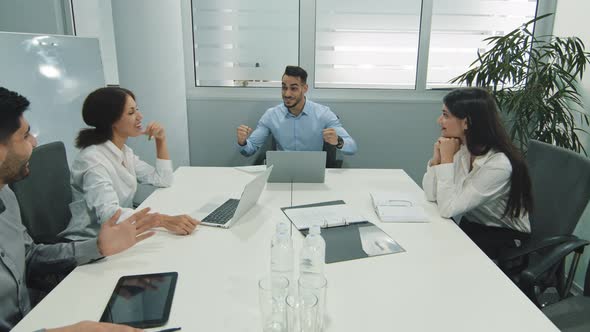 Excited Male Worker Sharing Good News with Happy Team Overjoyed Diverse Employees Group Screaming