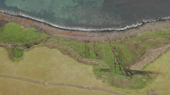 Bird's eye right to left trucking shot over Grimesy Island shoreline, Arctic Circle.