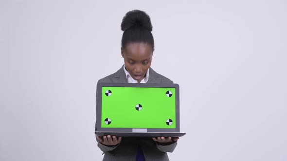 Young Happy African Businesswoman Showing Laptop and Looking Surprised