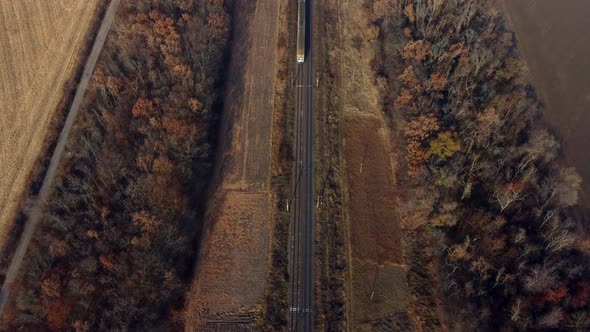 Aerial Drone View Flight Over Train Which Moves on Railroad on Autumn Sunny Day