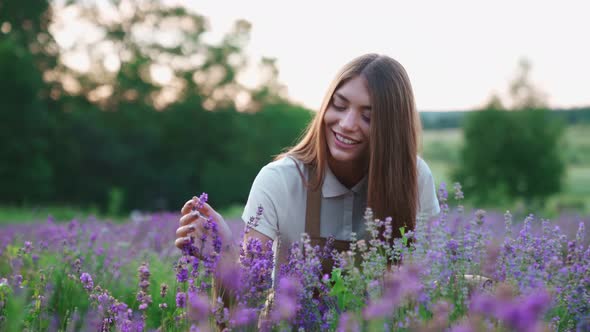 Smiling Woman Hugging Flowers in Lavender Field