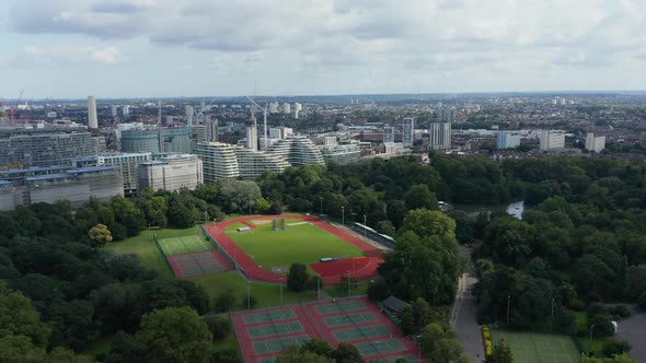Slide and Pan Footage of Millennium Arena and Tennis Courts in Battersea Park at Thames River