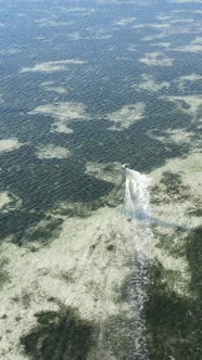 Vertical Video Kitesurfing Near the Shore of Zanzibar Tanzania