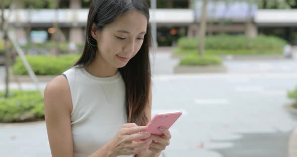 Woman using cellphone in the city 