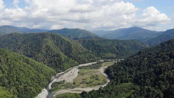 Aerial Flight with Drone Over Beautiful Green Mountains and River. 