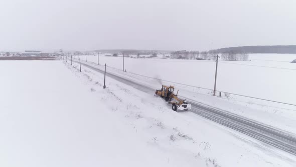 Aerial view of Snowblower Grader Clears Snow Covered Country Road 03