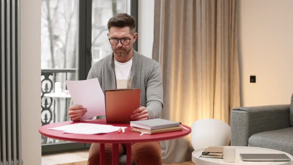 Man Working with Documents at Home