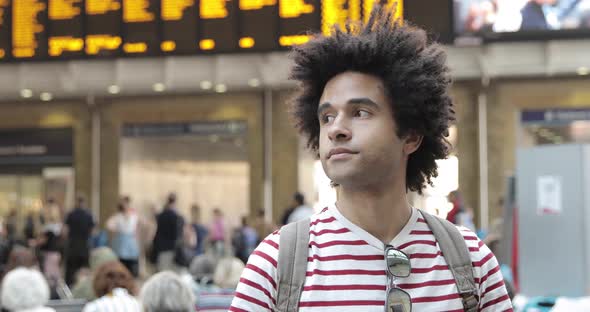 Mixed race man at train station portrait  - Afro caribbean man looking around