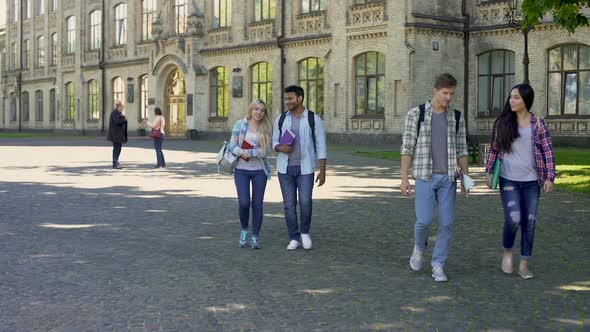 Mixed-Race Couples of Students Walking at University Courtyard After Classes