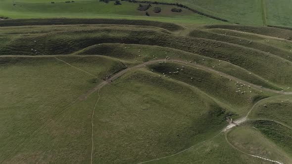 An aerial that tracks forward over Maiden castle towards the western gate which pans down as it appr