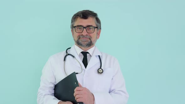 Portrait of a Senior Doctor in White Suit with Stethoscope and Registration Journal