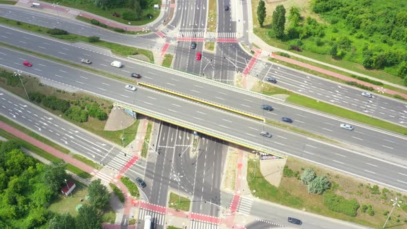 Aerial view of a freeway intersection. Clip. Highway and overpass with cars and trucks, interchange,