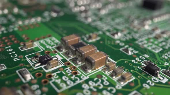 Extreme close-up of green Printed Circuit Board Electronics shot with dolly