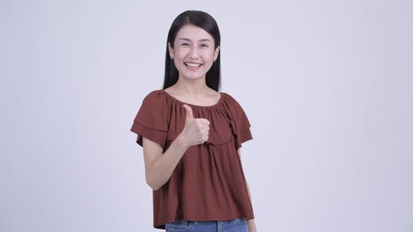 Happy Beautiful Asian Woman Giving Thumbs Up